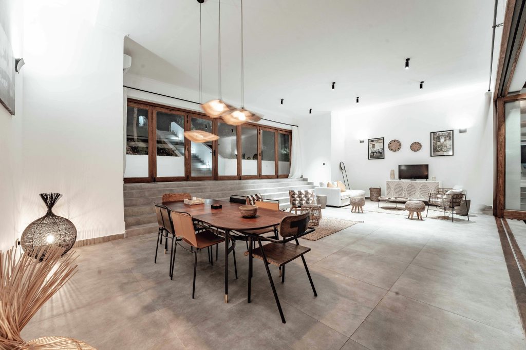 Stylish and spacious living room with modern decor and elegant lighting.