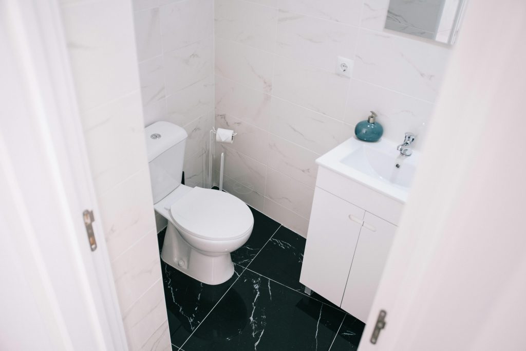 A contemporary bathroom showcasing a clean design with marble tiles and modern fixtures.